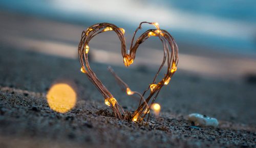 heart shaped with lights on the shore